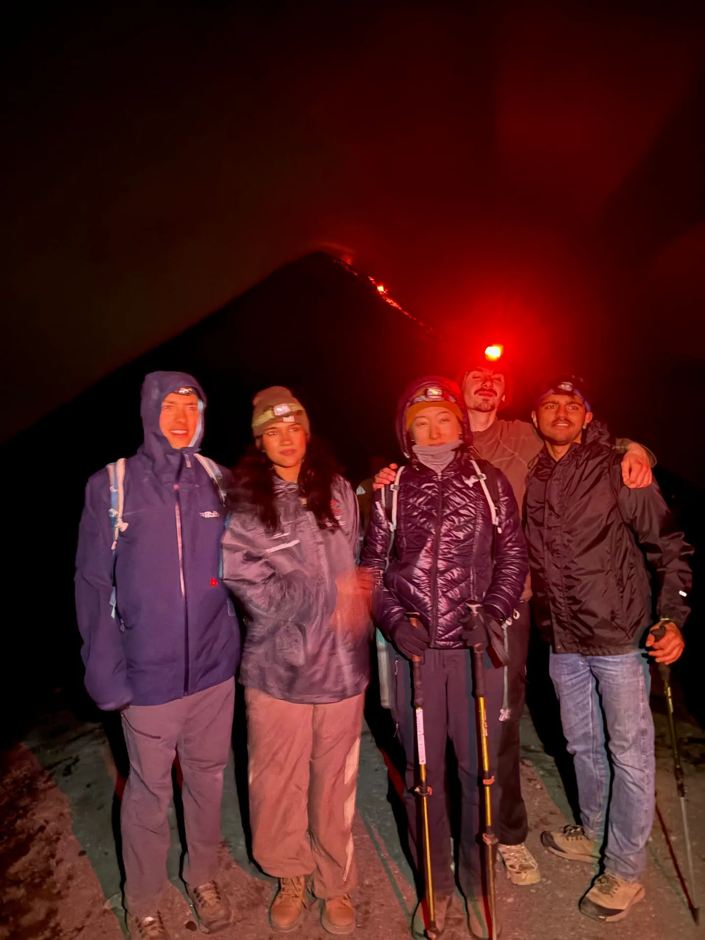 Friends we'd met on the hike, all trying our best to pose in the wind and freezing cold